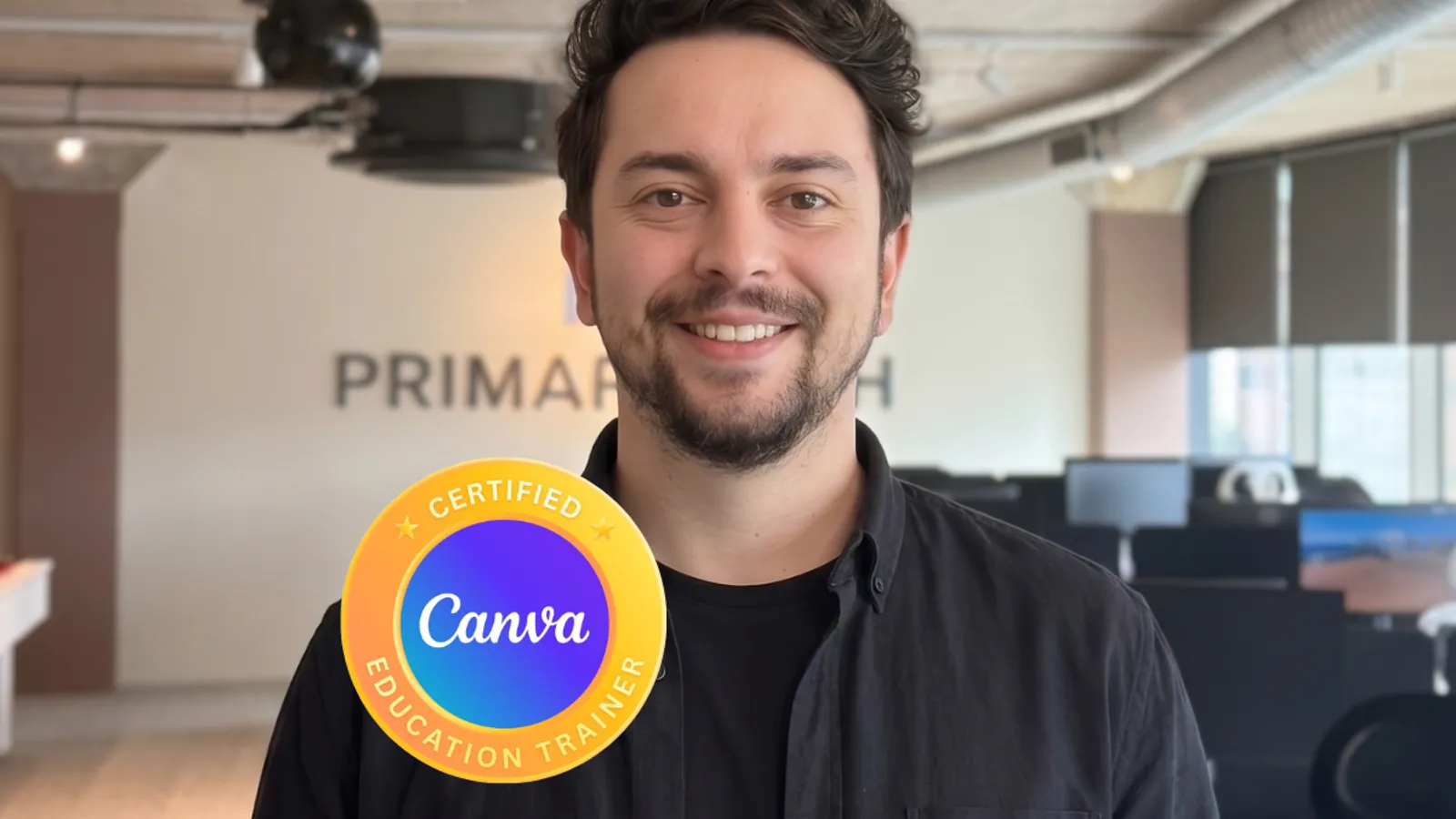 Devin Falvey, Digital Transformation Lead at Primary Tech, smiling to camera in the office, featuring Canva Certified Education Trainer badge.